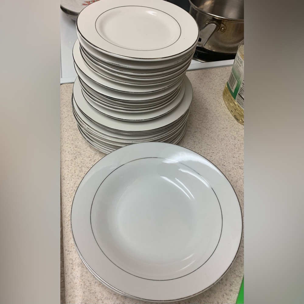We have 3 white bowls with a silver lining 11 white saucers 8 white bread plates